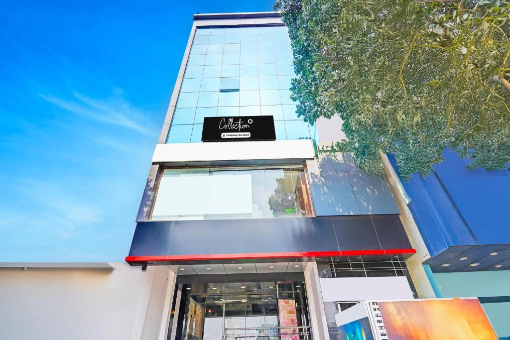 a building with a sign on the front of it at Collection O Niladri Road in Kammasandra