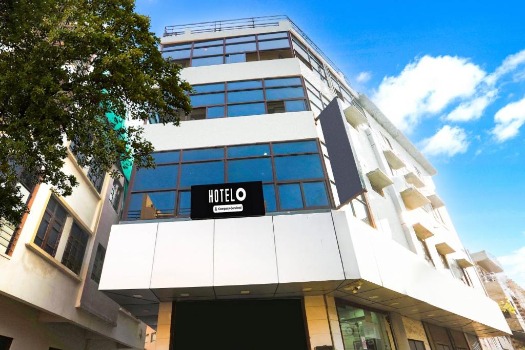 a building with a mico sign on the front of it at Hotel O Parao Formerly Cozy Inn in Ajmer