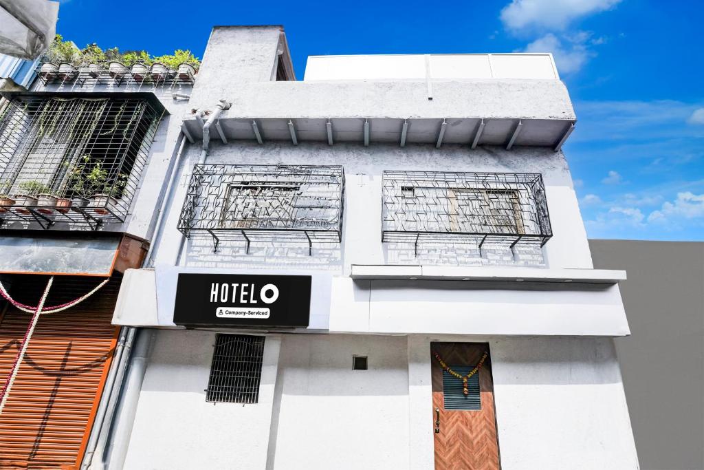 a white building with a hotel sign on it at Hotel O Khar East Near Railway Station in Mumbai