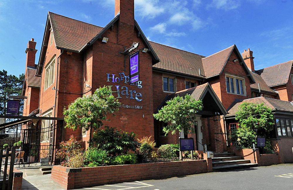 a large brick building with a sign on it at Hopping Hare in Northampton
