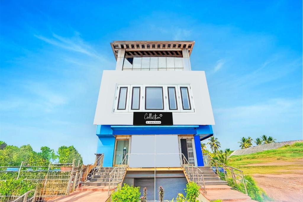 a blue and white building with a sign on it at Collection O Surathkal Beach Formerly Coastal Lodge in Suratakal