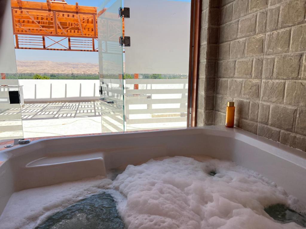a bath tub filled with lots of snow at Maat apartment in Luxor