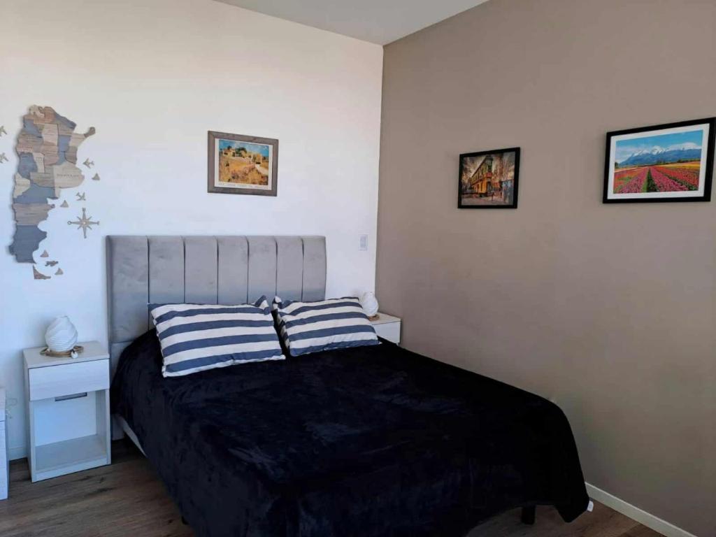 a bedroom with a bed and two pictures on the wall at Relax en Colegiales in Buenos Aires