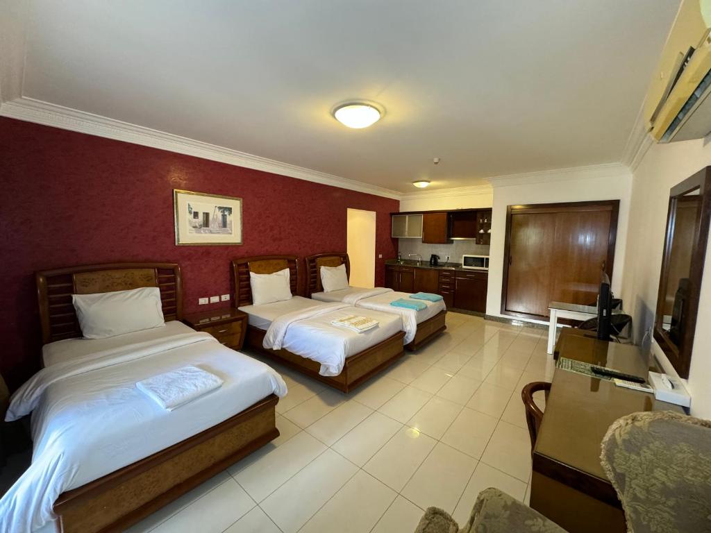 a hotel room with two beds and a kitchen at Herrmes in Sharm El Sheikh