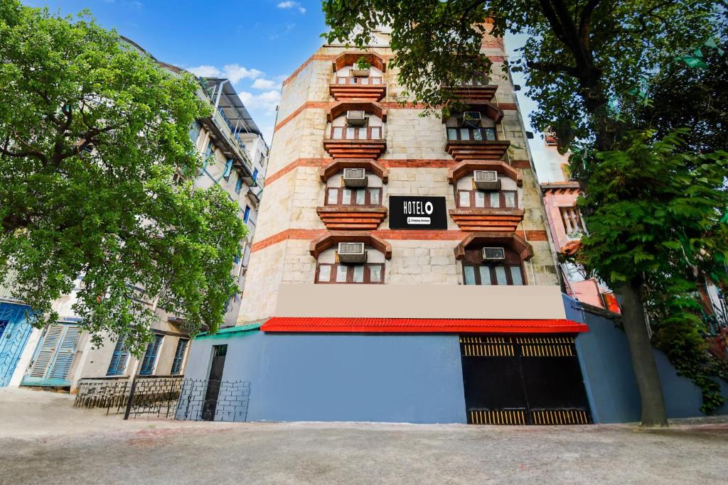a building with a sign on the side of it at Hotel O Alipore Near Chetla Formerly Alipore Guest House in Kolkata