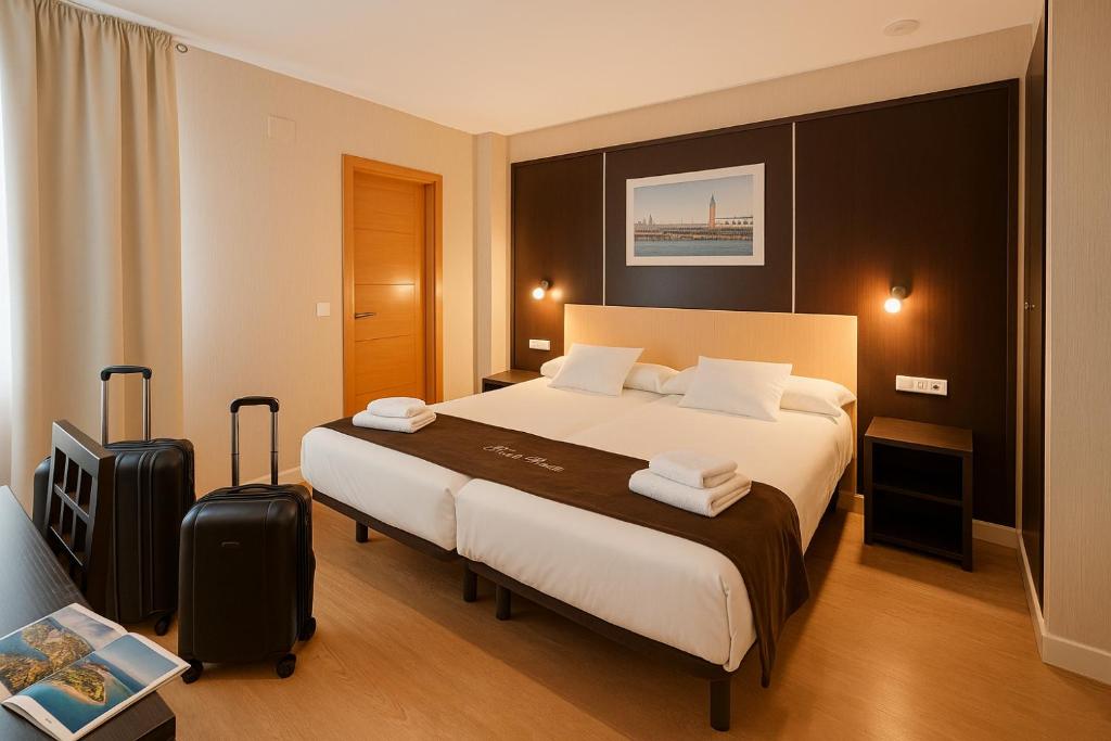 une chambre d'hôtel avec un lit et une valise dans l'établissement Hotel Plaza, à Séville
