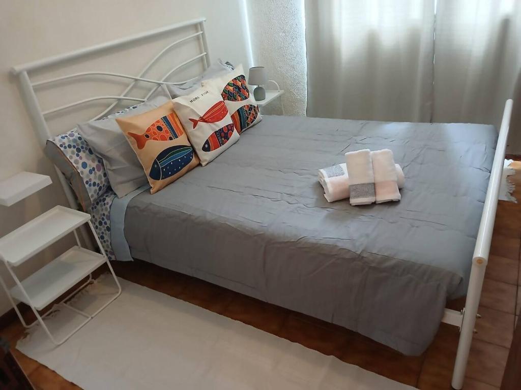 a bed with pillows on it in a bedroom at Porto Santo Sea View by Mth in Porto Santo