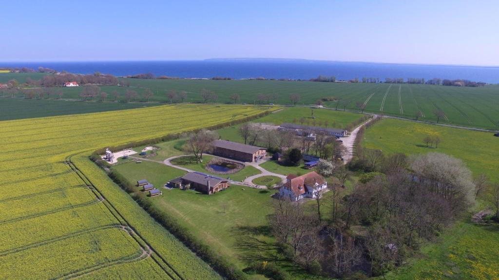 eine Luftansicht eines Betriebs mit einem Haus auf einem Feld in der Unterkunft Hofgut Wollin GmbH in Putgarten