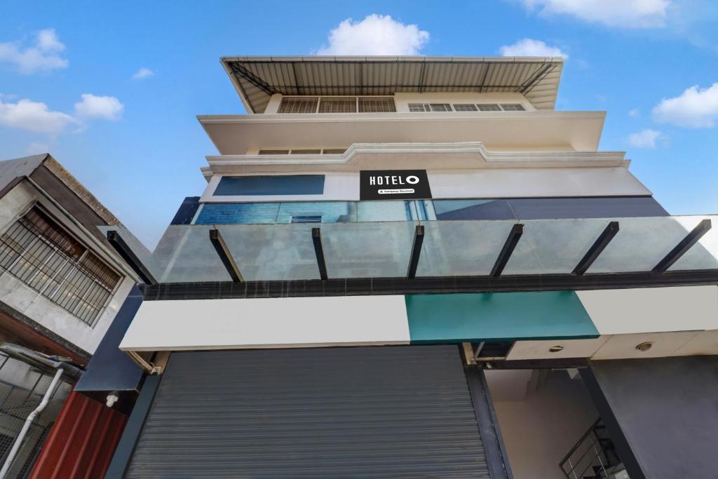 a building with a hotel sign on it at Super Hotel O Anayara Near Lulu Mall Formerly Timber Residency in Trivandrum