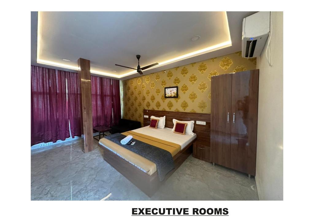 a bedroom with a bed and a tv in it at Athithi Comforts in Mysore