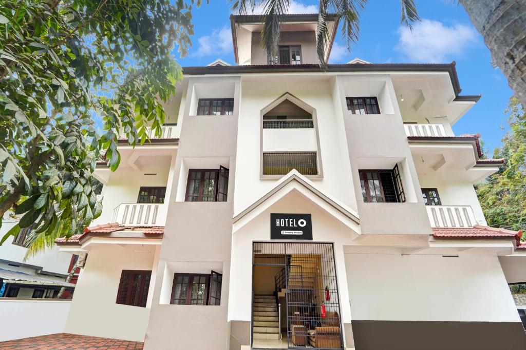 a white building with a sign that reads hilto at Hotel O West Hill near Mietra Hospital in Calicut
