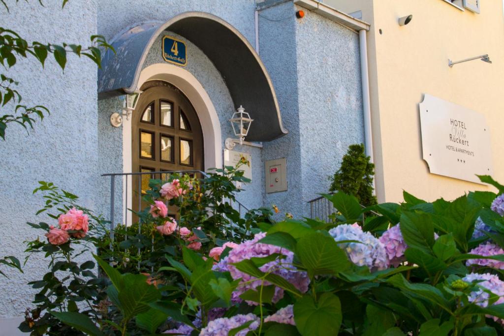 a building with a door and flowers in front of it at Hotel Villa Rückert in Graz