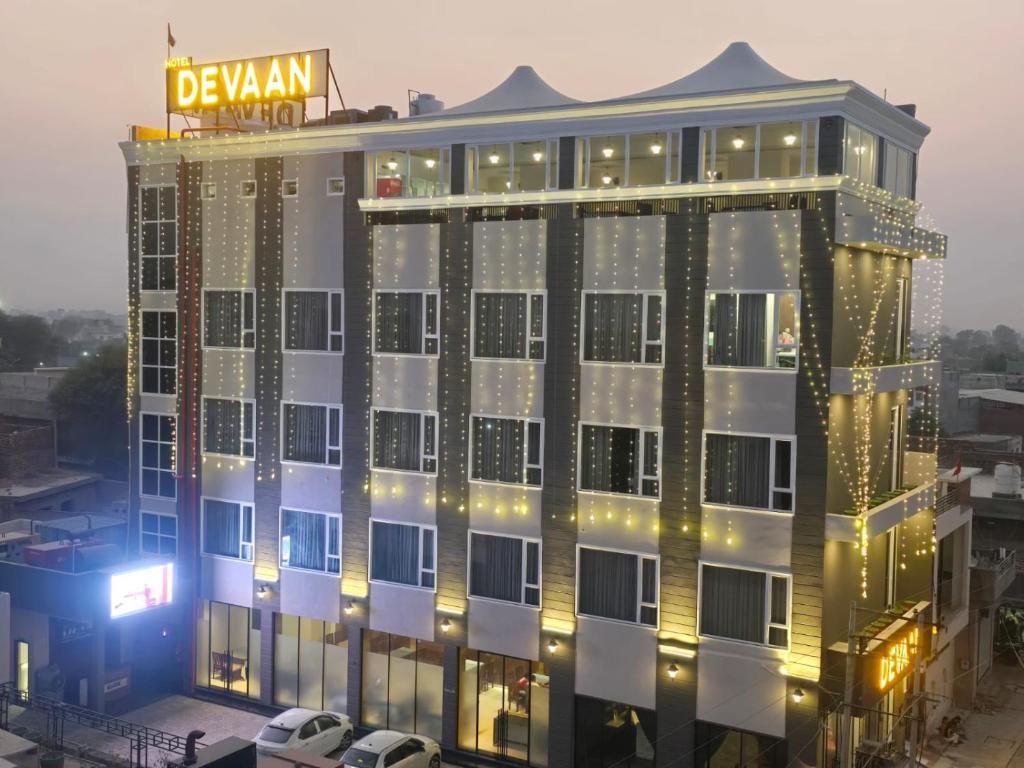 a building with a sign on top of it at Hotel Devaan in Kālānwāli
