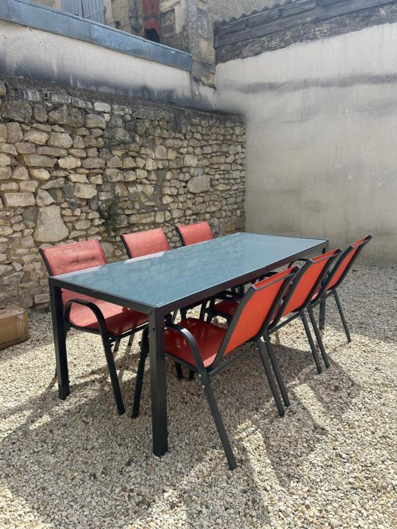 a table with four chairs sitting around it at Casa Victoria in Ruelle-sur-Touvre