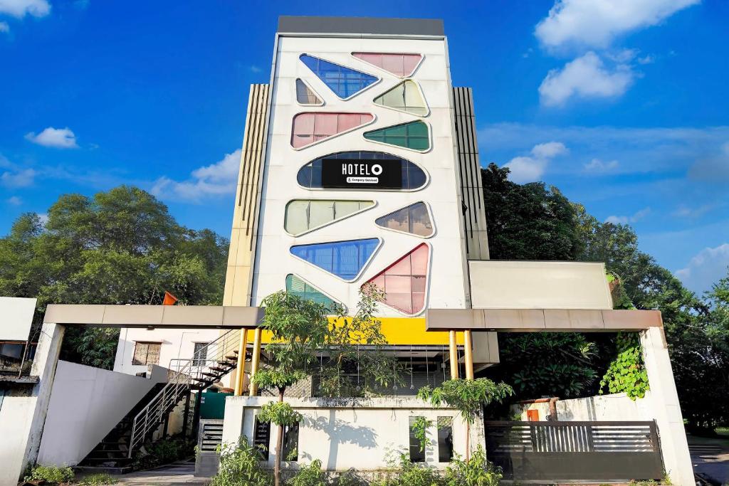 a building with colorful windows on it at Super Hotel O Katol Road Friends Colony in Nagpur