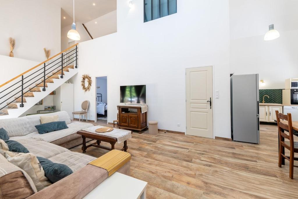 a living room with a couch and a table at Charme nature et grand espace in Saint-Setiers