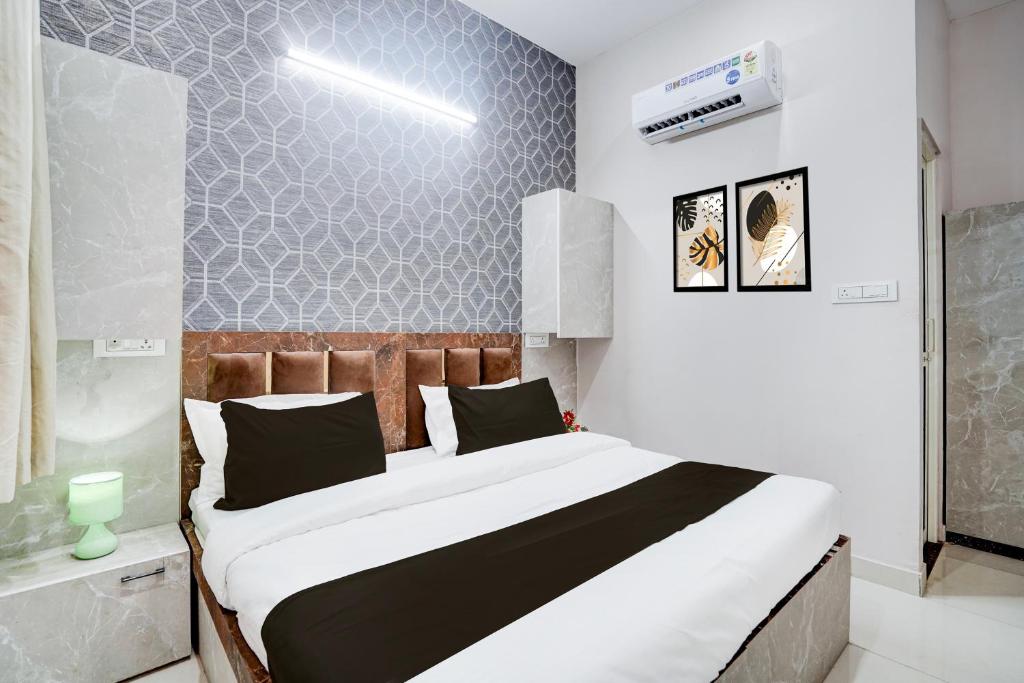 a bedroom with a large bed in a room at Super Townhouse Vasundra Nagar Formerly Joystel in Jaipur
