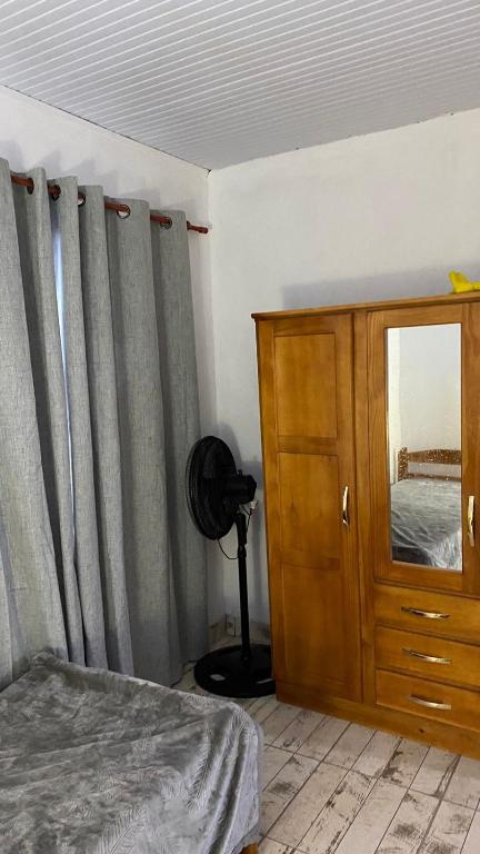 a bedroom with a bed and a dresser and a mirror at San vicente misiones in San Vicente