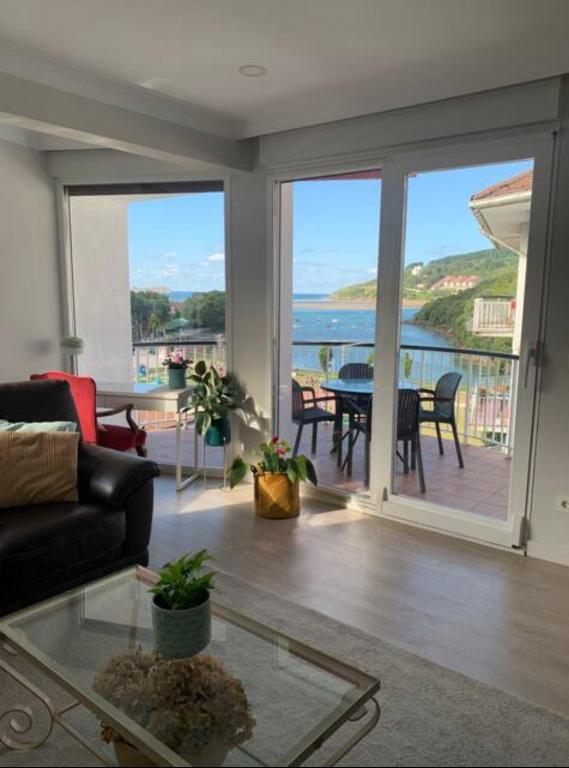 a living room with a couch and a view of the ocean at Urdaibai Luxy in Pedernales