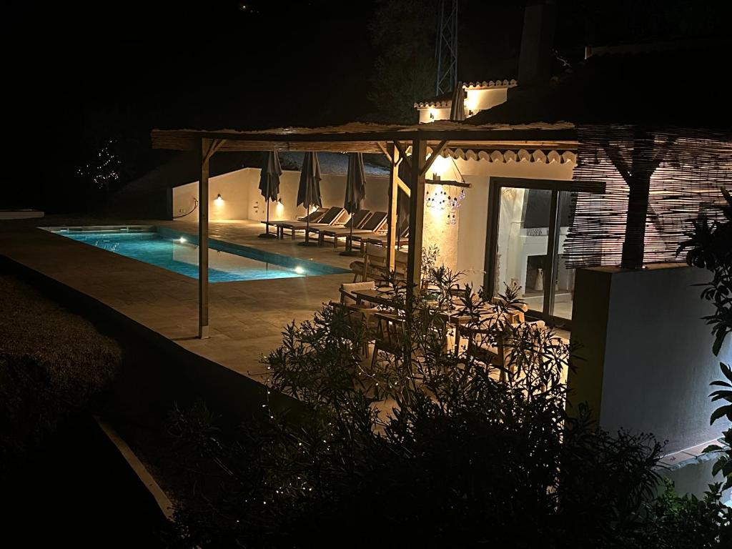 a house with a swimming pool at night at Finca Celia Competa in Cómpeta