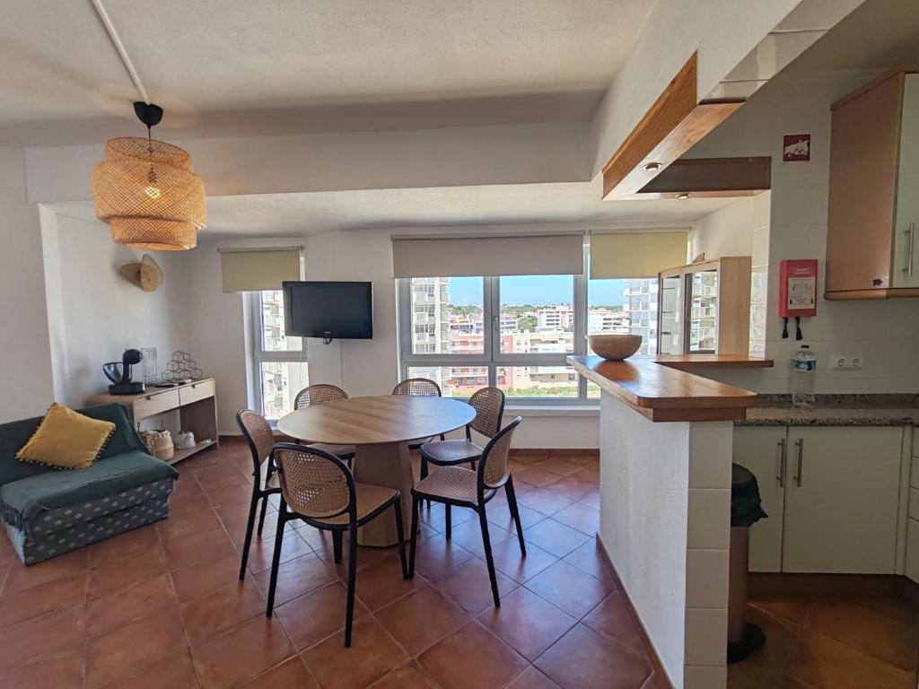 a kitchen and dining room with a table and chairs at 11A Rocha - Casas & Papeis in Armação de Pêra