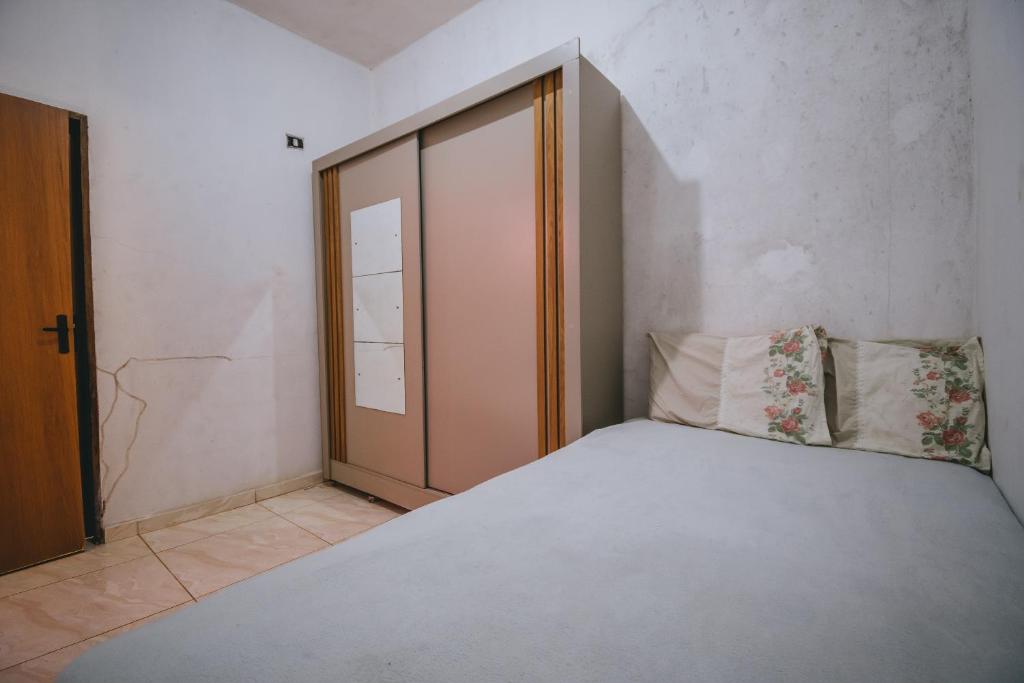 a bedroom with a bed and an open door at Doce Lar 58- Quarto Exclusivo in Cabo de Santo Agostinho