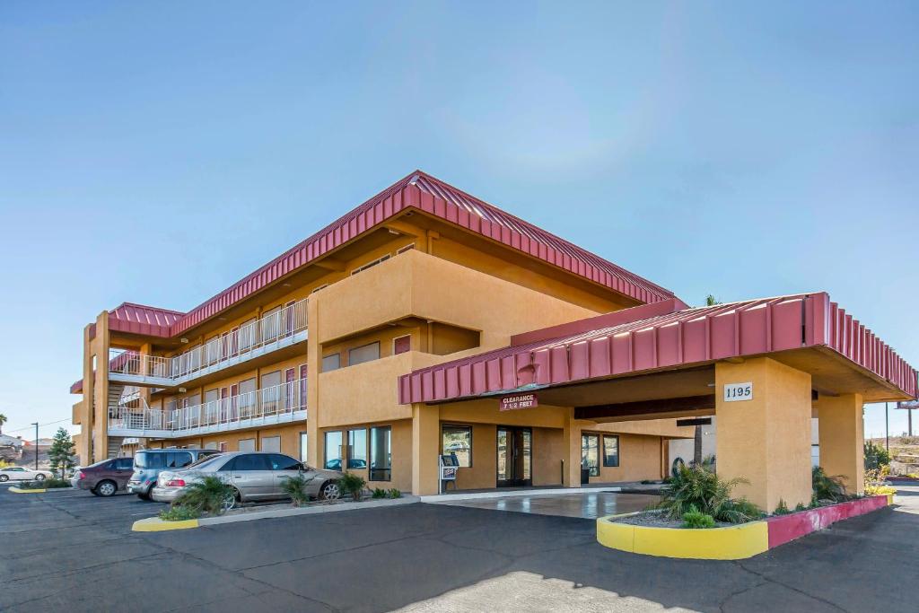 a hotel building with cars parked in a parking lot at Quality Inn - Needles in Needles
