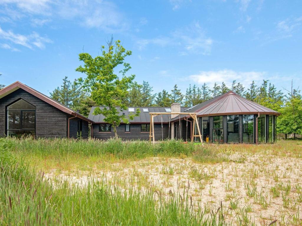 a house in the middle of a field at 14 person holiday home in Løkken in Løkken