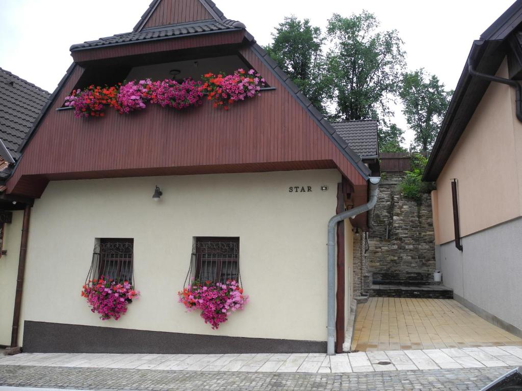 a building with flowers on the side of it at Star in Poprad