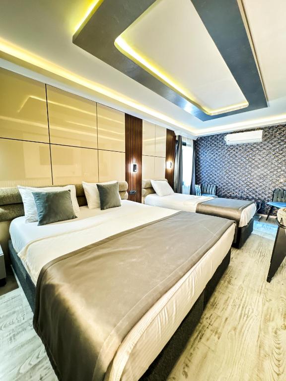 a hotel room with two beds and a couch at AMARA OLD CITY HOTEL & Spa in Istanbul