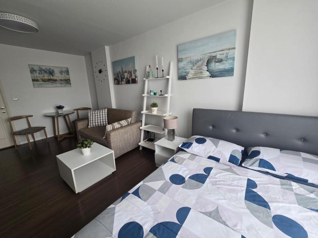 a bedroom with a bed and a living room at Downtown Hua Hin Condo with Pool in Hua Hin