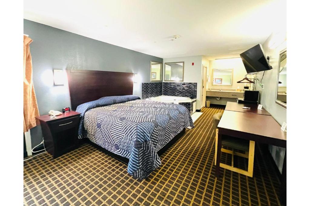 a hotel room with a bed and a desk at Lake Seminole Inn in Sneads