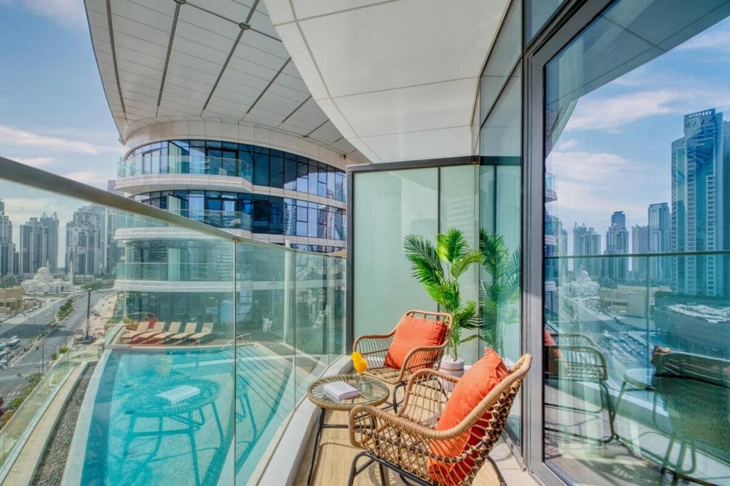 a balcony with a view of a city at GYL Holiday Homes -Imperial Avenue - Luxury Retreat Apt with Burj Khalifa Pool View - Near Dubai Mall in Dubai