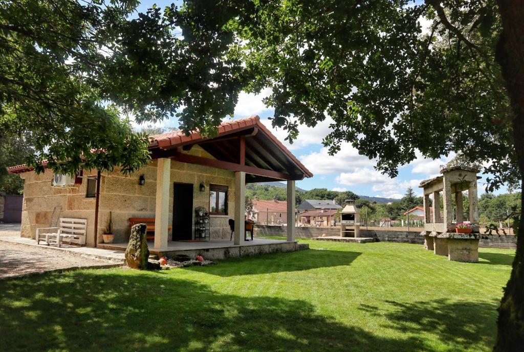 a house with a green lawn in front of it at Vilaboa Paradise in Villanueva