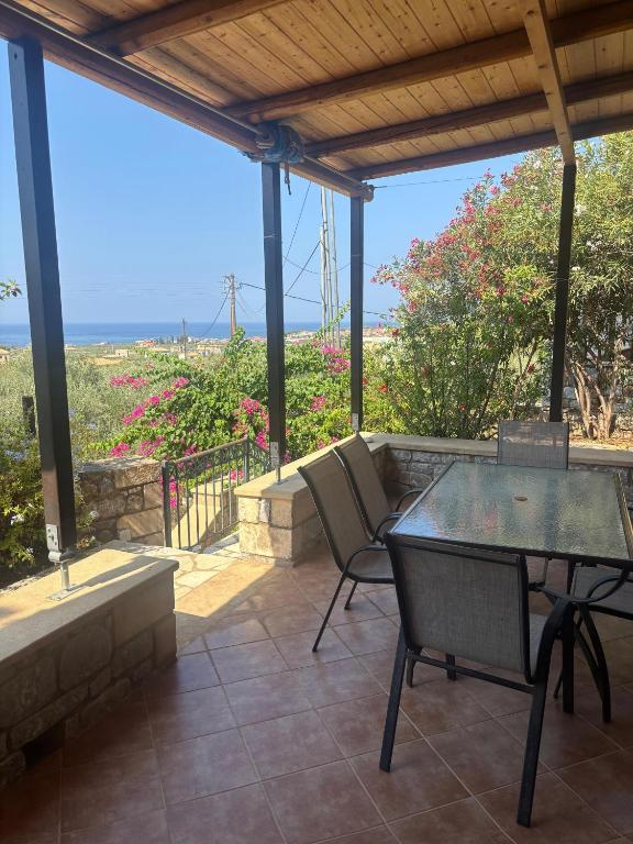 a table and chairs on a patio with a view at Villa Panόrama in Riglia