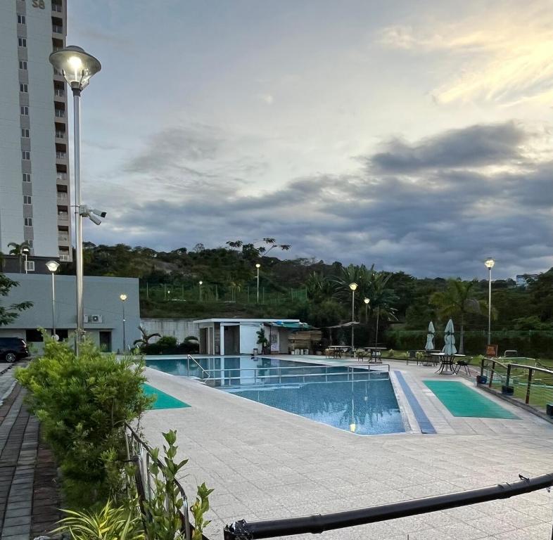 a large swimming pool in a building with a cloudy sky at Spacious Condo in Clark! Free Parking in Fort Stotsenburg