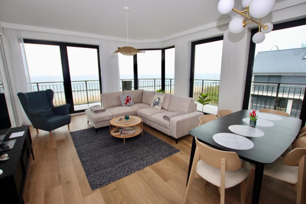 a living room with a couch and a table at Porto Mare Apartamenty in Skorka