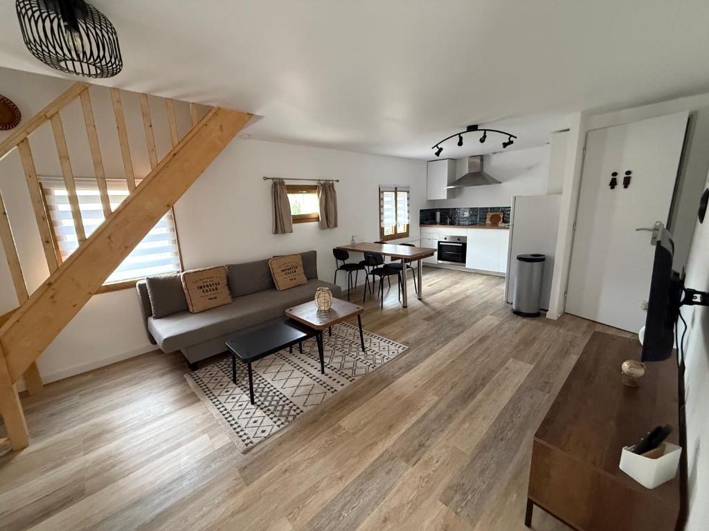 a living room with a couch and a table at La Rêverie in Le Thor