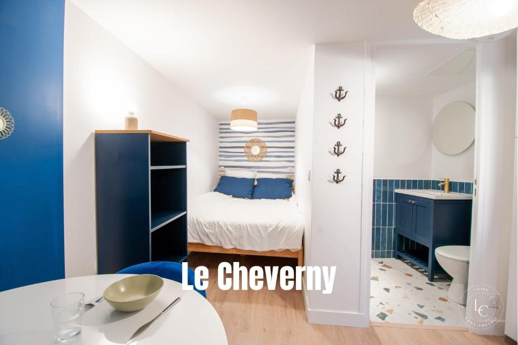 a small bedroom with a bed and a bathroom at Le Cheverny Apartment Cozy stay near the Loire castles in Courbouzon
