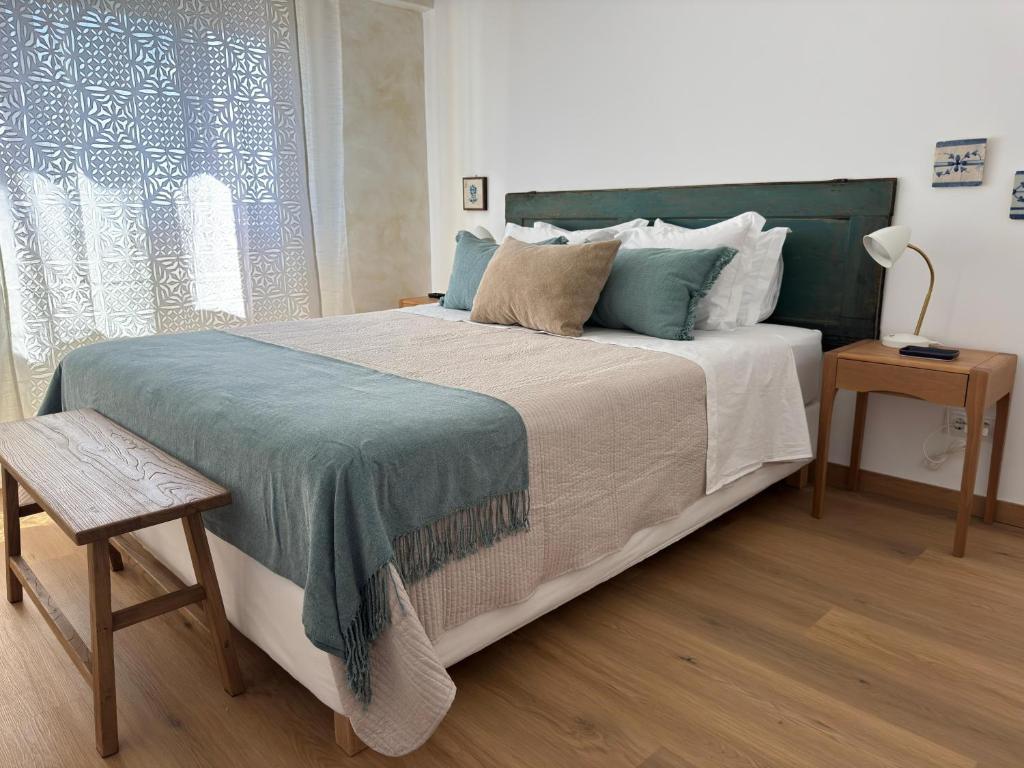 a bedroom with a large bed and a window at WHome Seaside Getaway Beachfront Apartment in Estoril