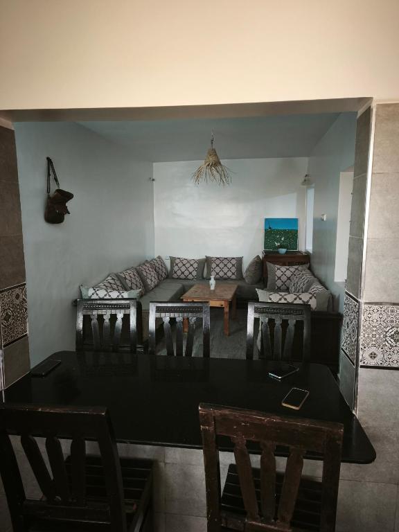 a living room with a couch and a table at Dar ifoulki in Wassane