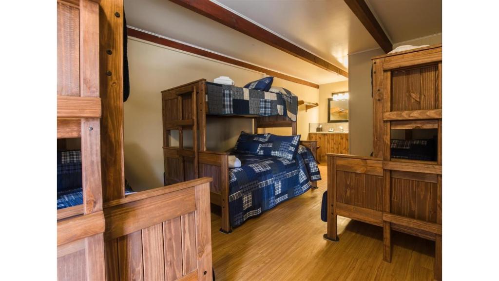 a bedroom with a bunk bed and wooden cabinets at St James A1 in Cimarron