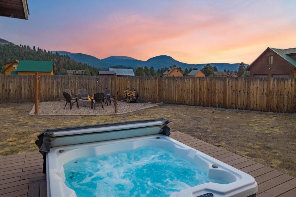 a hot tub sitting on a deck in a backyard at Stapp Mountain Retreat in South Fork, CO in South Fork
