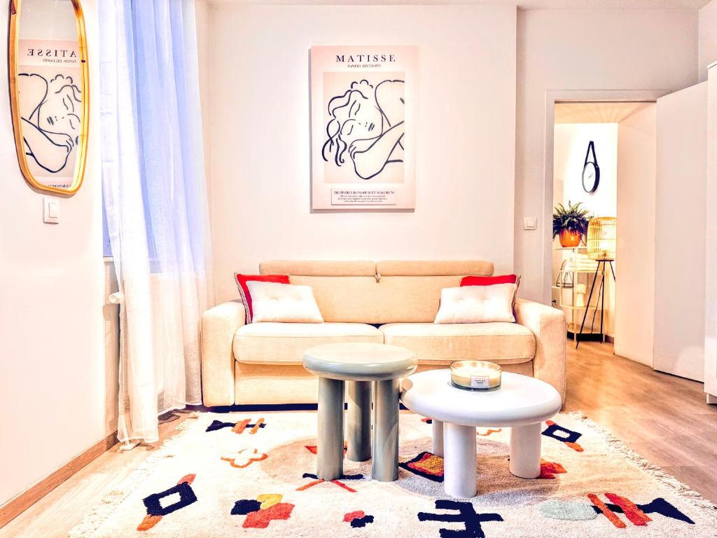 a living room with a couch and a table at Casa Lairesse in Liège