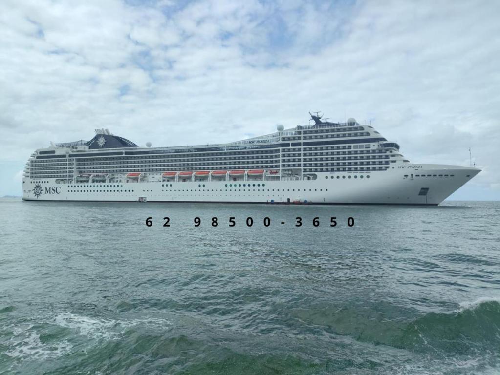 a cruise ship sitting in the ocean at Balneário Camboriú 3 quartos Avenida Atlântica in Balneário Camboriú