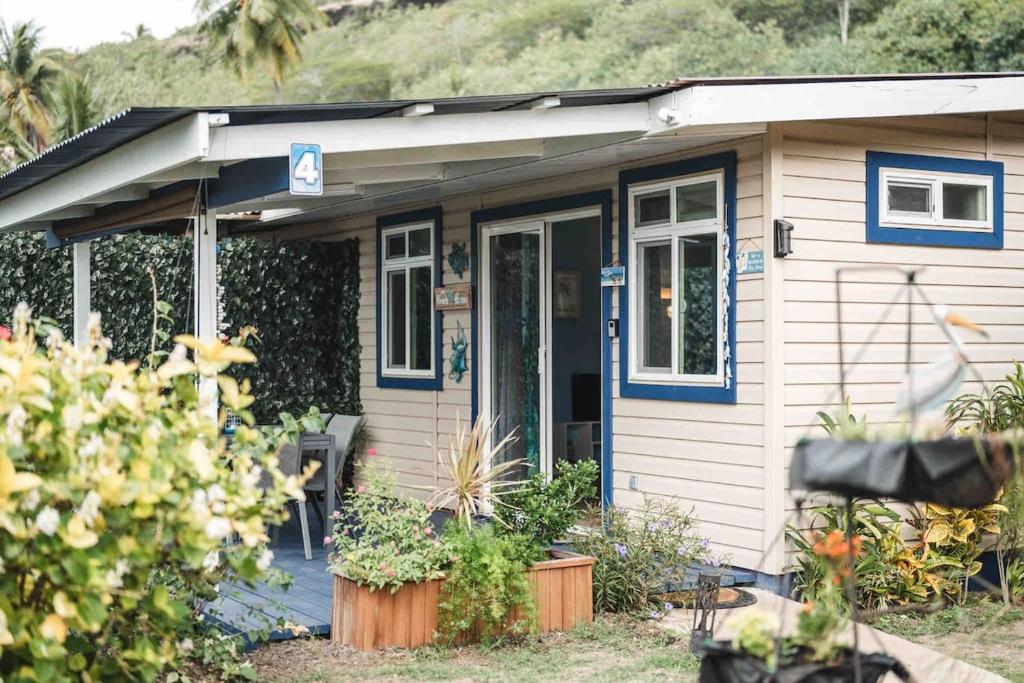 a small house with a porch and a door at Matira Blue House in Bora Bora