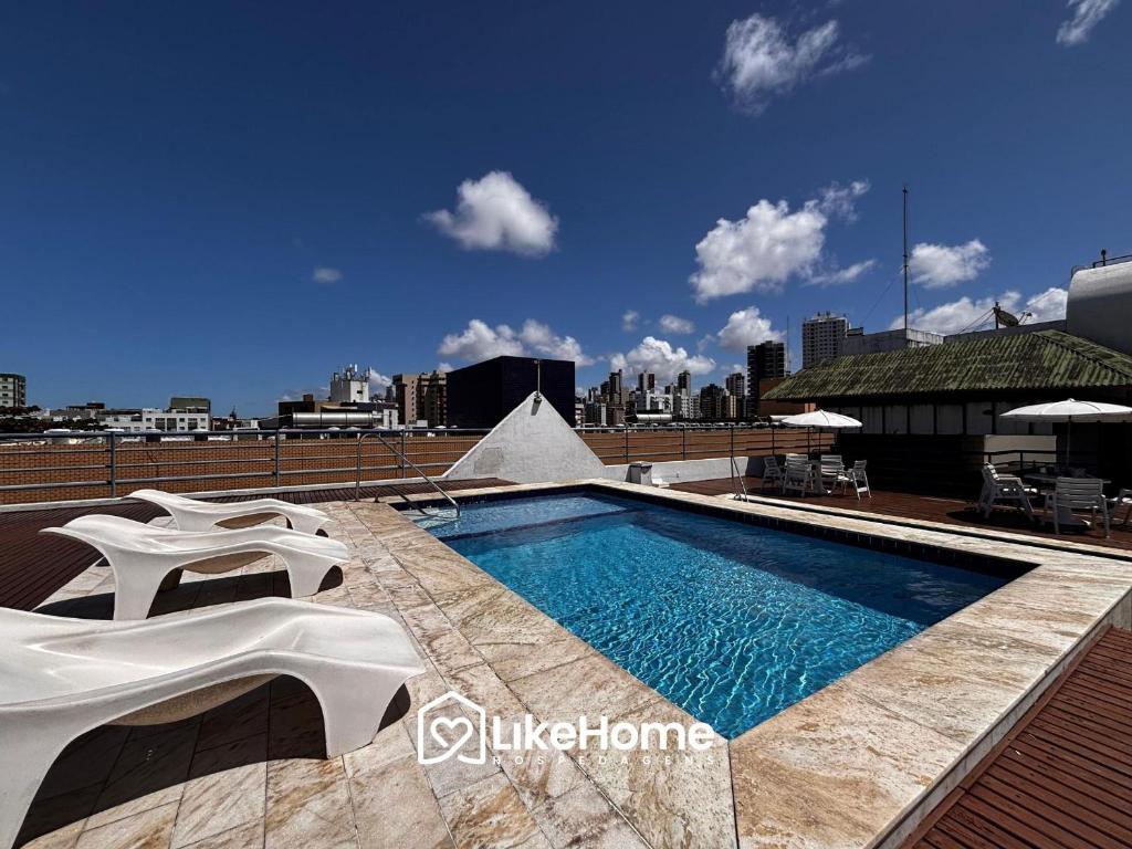 a swimming pool on the roof of a building at Royal Flat in João Pessoa
