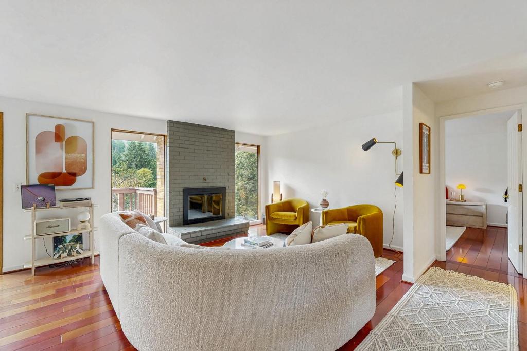 a living room with a couch and a fireplace at The Canopy House in Eugene