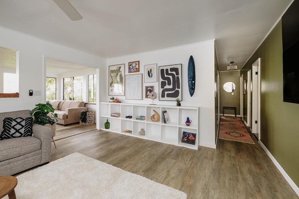 a living room with a couch and a table at Lihau Boho House in Kailua-Kona