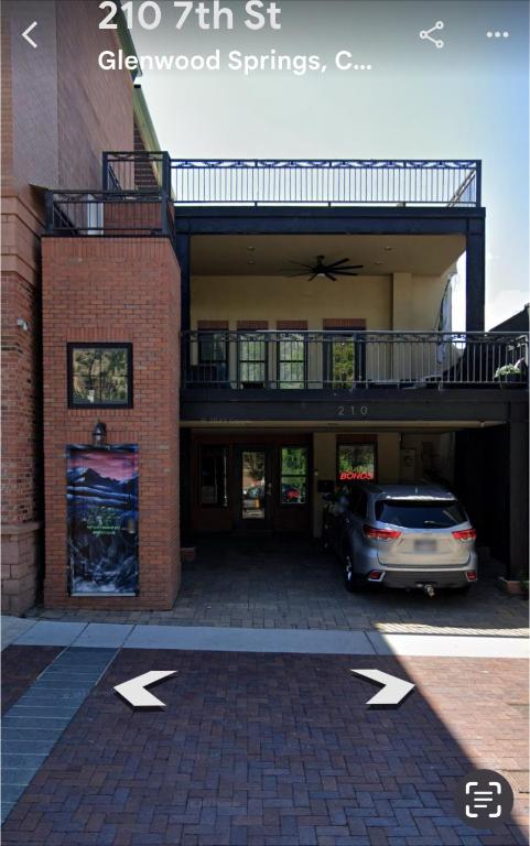 a car parked in a parking lot in front of a building at 420 LOFT in Glenwood Springs
